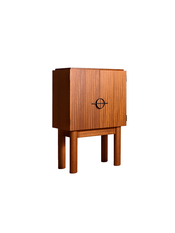 Chop Cabinet by Veermakers – mahogany, upright cabinet on cylindrical legs with circular metal handle, vertical wood grain doors